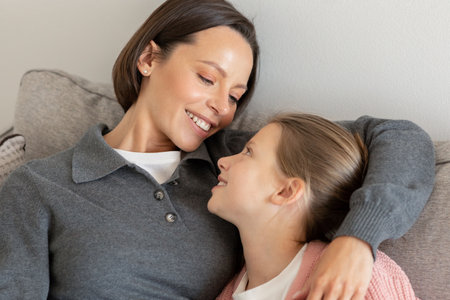 Cheerful young caucasian lady hug teen daughter, talk, have fun, enjoy love, free time, comfort in...