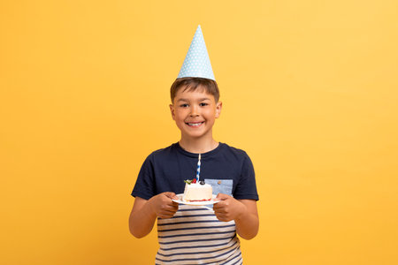 Happy handsome cute birthday boy holding birthday cakeの写真素材