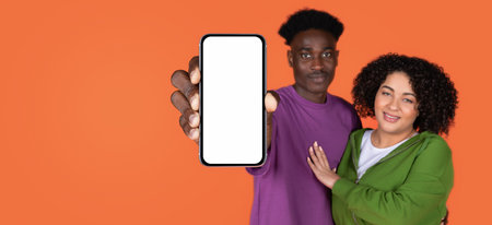 Positive mixed race couple showing big cell phone, mockup