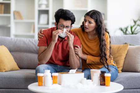 Family Support. Loving Indian Woman Taking Care About Her Ill Husbandの写真素材