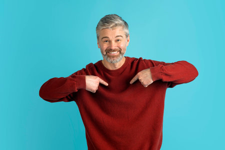 Cool middle aged man in casual outfit pointing at himselfの写真素材