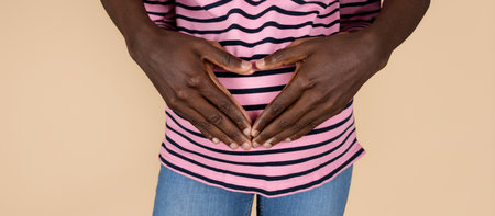 Millennial african american guy hugging woman with big belly, make heart sign with hands