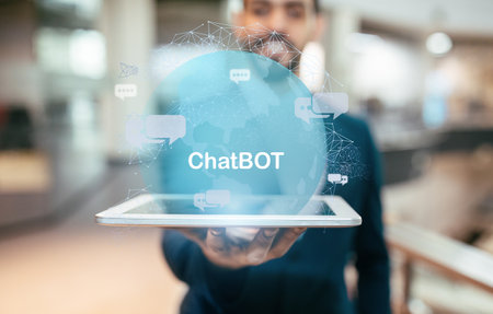 Middle eastern businessman showing digital tablet with chatbot hologramの写真素材