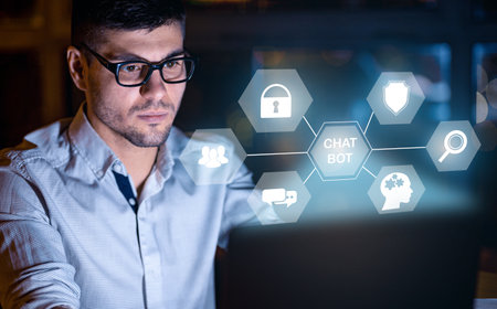 Young man wearing eyeglasses working on laptop, using artificial intelligence