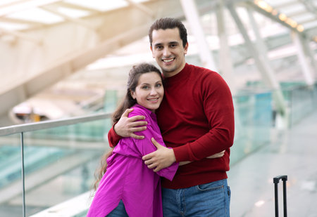 Romantic Young Tourists Couple Embracing Posing At Modern Airportの写真素材