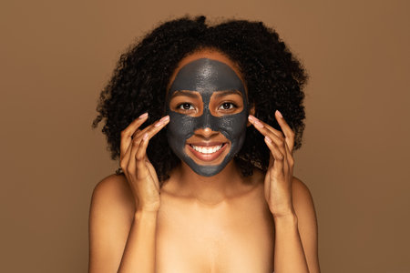 Black woman with purifying black mask on her faceの写真素材