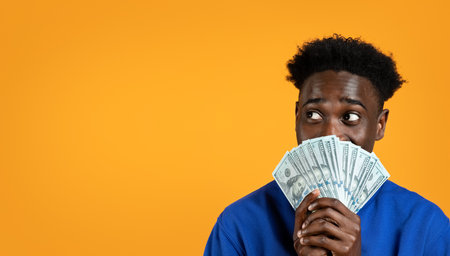 African american young man holding cash money, copy spaceの写真素材