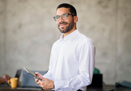 Successful Arabic Businessman In Eyeglasses Holding Digital Tablet In Office