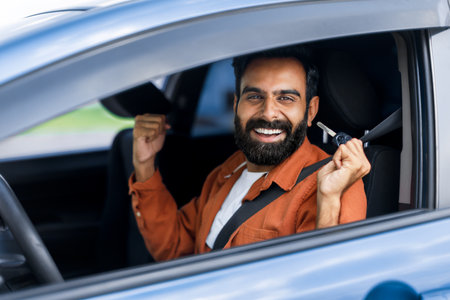 Excited Arab Driver Man Shaking Clenched Fists In Carの写真素材