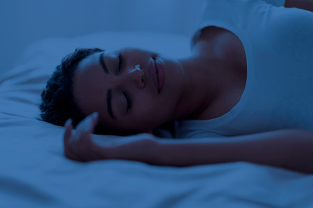 Portrait of young african american woman sleeping in bed in the night