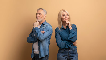Pensive curious elderly man and woman looking at copy space