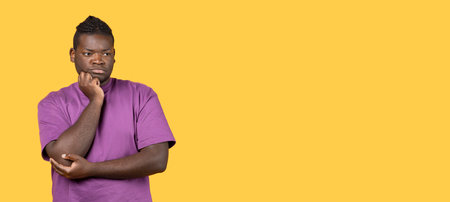 Depressed Black Guy Thinking About Problems Posing Over Yellow Backgroundの写真素材