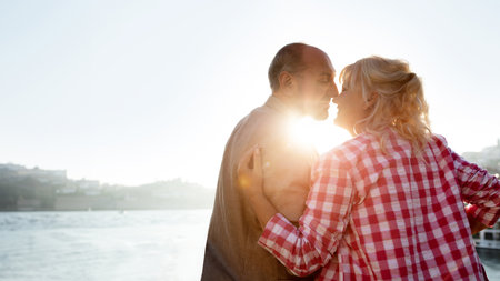Mature Love Story. Romantic Senior Couple Kissing Outdoors At Sunset Timeの写真素材