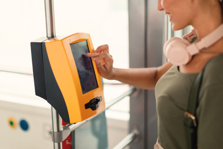 Passenger Woman Using Ticket Machine In Modern Tram Indoor, Croppedの写真素材