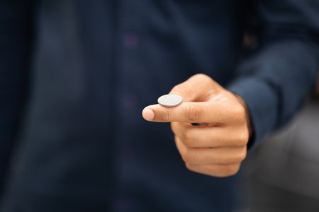 Mans hand throwing up coin to make a decision