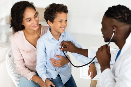 Mother And Son Visiting Family Doctor During Appointment In Clinicの写真素材
