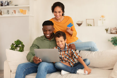 Multiracial Family Using Laptop And Credit Card Shopping Online Indoorの写真素材