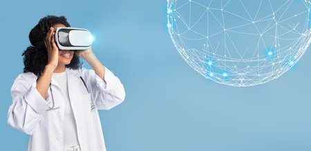 Cheerful inspired black millennial lady doctor in white coat, vr glasses looks at abstract glowing ballの写真素材
