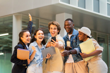 Multiracial group of students taking selfie on smartphone at campusの写真素材