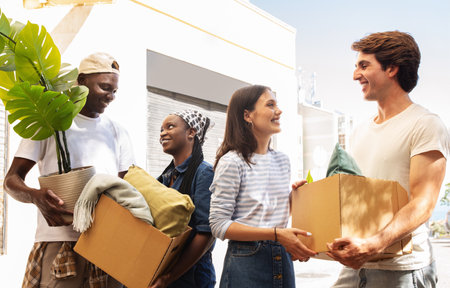 Positive young multiracial people friends moving to new house