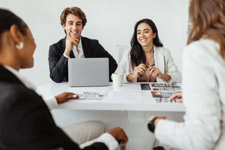 HR workers hiring two female candidates, making employment deals, signing work contract after successful job interviewの写真素材
