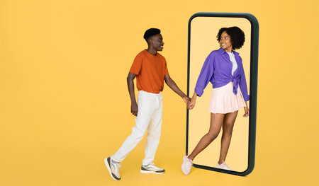 Positive millennial black wife in casual hold man hand, leads to big smartphone, enjoy date and free...