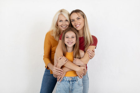 Beautiful preteen girl, millennial woman and senior lady on white