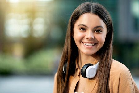 Pretty young brunette hispanic lady student posing at college campusの写真素材