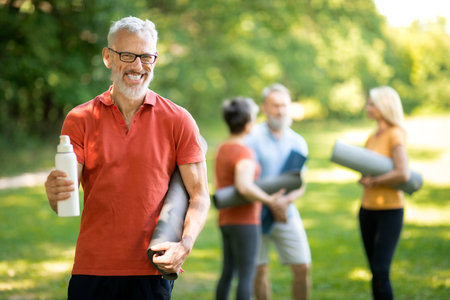 Handsome Senior Man Posing Outdoors During Group Sport Trainingの写真素材