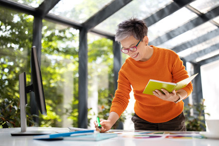 Stylish middle aged woman designer working with color palette