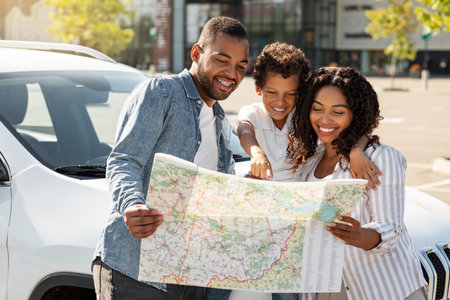 Loving african american family going car trip, checking mapの写真素材