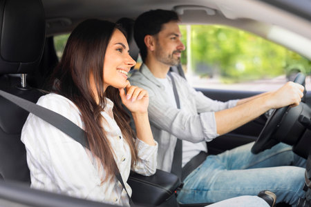 Happy caucasian man and woman going on vacation by car