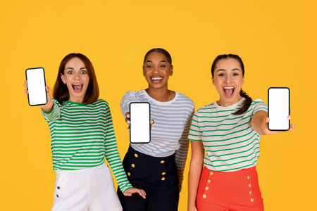 Cute pretty multiethnic women showing phones with white screen