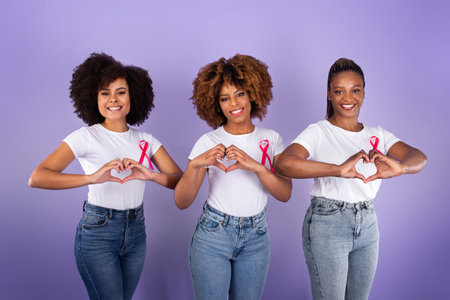 Black Ladies With Breast Cancer Ribbons Gesturing Heart Shape, Studioの写真素材