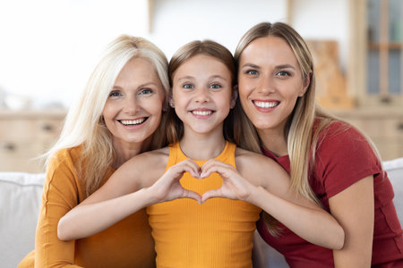 Mother, daughter and granddaughter posing at home