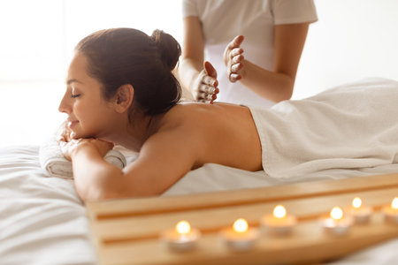 Young Woman Having Relaxing Body Massage Session In Wellness Centerの写真素材