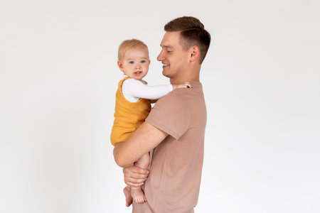 Parenthood Concept. Happy young dad enjoying time with his infant baby