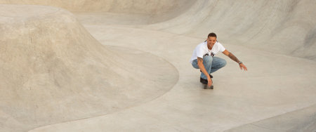 Young european man skillfully performing skateboard tricks at park