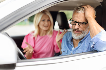 Stressed elderly man sitting in car, have fight with wifeの写真素材