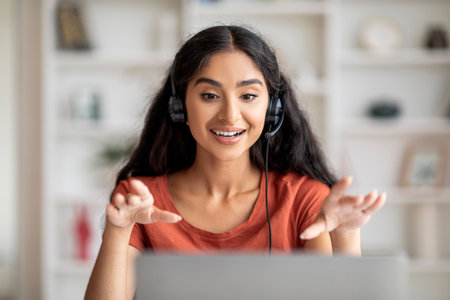 Focused Young Adult Hindu Lady Navigating Virtual Work