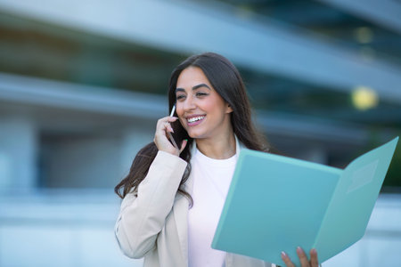 Smiling Lady Talking On Phone Holding Folder With Documents Outside