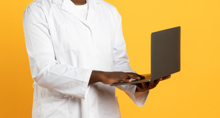 Unrecognizable African American Man Doctor Using Laptop On Blue Backgroundの写真素材
