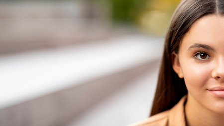 Half face of pretty young woman posing outdoor