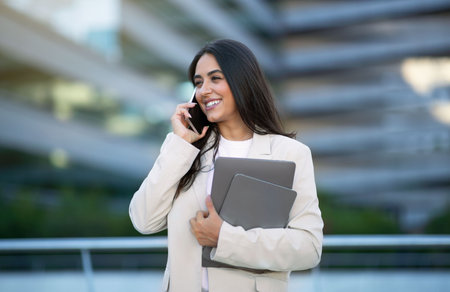 Happy Young Business Woman Talking On Cell Phone Outsideの写真素材