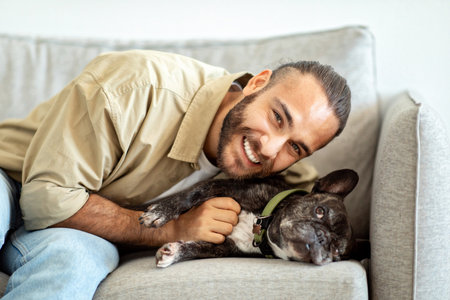 Happy young man with his dog at home
