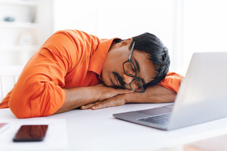 Mature indian man employer sleeping at workplaceの写真素材