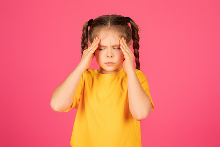 Cute Little Girl Suffering Headache, Touching Head With Handsの写真素材