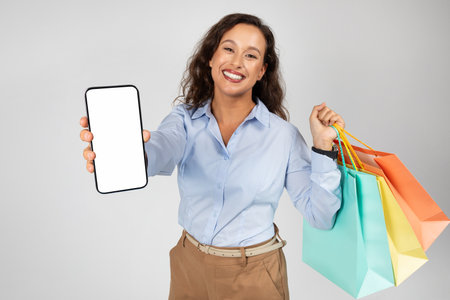 Positive young caucasian lady in formal wear, many purchases bags, enjoy shopping