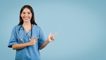 Smiling young female nurse pointing to side at free spaceの写真素材