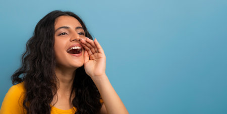 Excited young indian woman screaming towards copy spaceの写真素材